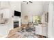Open living space with hardwood floors, fireplace, and sliding door to a deck at 5504 Creekdale Cir, Raleigh, NC 27612