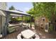 Expansive backyard with a deck, complete with seating, grill, canopy, and a charming playhouse, great for Gathering fun at 5512 Bridgeman Ct, Durham, NC 27703