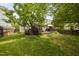 Sprawling backyard featuring a deck, mature trees, and a lush lawn, creating an ideal space for outdoor activities at 5512 Bridgeman Ct, Durham, NC 27703