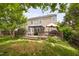 An outdoor wood deck with furniture, an umbrella, and a grill is attached to the home with a large yard at 5512 Bridgeman Ct, Durham, NC 27703