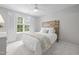 Bright bedroom with a ceiling fan, large window, wood headboard, and soft carpet at 5512 Bridgeman Ct, Durham, NC 27703