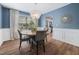 Dining room with modern chandelier and wainscoting at 5512 Bridgeman Ct, Durham, NC 27703