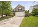 This two-story home boasts a pristine lawn and a spacious two-car garage at 5512 Bridgeman Ct, Durham, NC 27703
