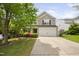 Classic two-story home featuring a two-car garage and lush landscaping at 5512 Bridgeman Ct, Durham, NC 27703