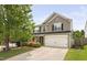 Charming two-story home boasts a well-manicured front yard, two-car garage and patriotic display at 5512 Bridgeman Ct, Durham, NC 27703