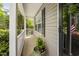 Cozy covered porch showcases a charming potted plant at 5512 Bridgeman Ct, Durham, NC 27703