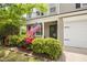 Inviting front porch adorned with vibrant landscaping and an American flag at 5512 Bridgeman Ct, Durham, NC 27703