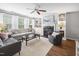 Spacious living room with a fireplace, ceiling fan, and lots of natural light at 5512 Bridgeman Ct, Durham, NC 27703