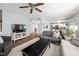 Open living area with ceiling fan, gray sofa, and a view into the kitchen at 5512 Bridgeman Ct, Durham, NC 27703