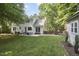 Back of the house with a nice backyard featuring a seating area at 5642 Falkirk Dr, Durham, NC 27712