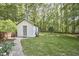 A storage shed is nestled in the expansive, lush, fenced backyard at 5642 Falkirk Dr, Durham, NC 27712