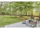 Picture of a spacious backyard with patio seating and lush green trees at 5642 Falkirk Dr, Durham, NC 27712