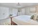 Bright bedroom featuring a wooden bed frame, carpet flooring, and plenty of closet space at 5642 Falkirk Dr, Durham, NC 27712
