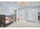 This light blue Bedroom features a crib, two large closets, and a light fixture at 5642 Falkirk Dr, Durham, NC 27712