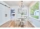 Breakfast nook with sliding barn door leading to living room and views of the large, green backyard at 5642 Falkirk Dr, Durham, NC 27712