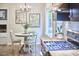 Bright breakfast nook with a round table and a view of the backyard, next to the kitchen at 5642 Falkirk Dr, Durham, NC 27712
