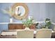 Close up view of the dining room with wood table, light blue walls, and decor at 5642 Falkirk Dr, Durham, NC 27712