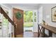 Welcoming foyer with hardwood floors, a wooden console table, and an open view to the outdoors at 5642 Falkirk Dr, Durham, NC 27712