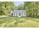 Inviting single-story home with lush green lawn and mature trees in the front yard at 5642 Falkirk Dr, Durham, NC 27712