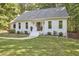 Charming home with green front lawn, large windows, and stylish door at 5642 Falkirk Dr, Durham, NC 27712