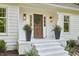 Charming entryway with updated lighting, decorative plants, and freshly painted stairs at 5642 Falkirk Dr, Durham, NC 27712