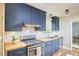 This lovely kitchen includes blue cabinets, wooden countertops, and stainless steel appliances at 5642 Falkirk Dr, Durham, NC 27712