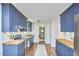 Updated kitchen with blue cabinets, butcher block countertops, and stainless steel appliances at 5642 Falkirk Dr, Durham, NC 27712
