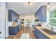 Spacious kitchen with blue cabinets, butcher block countertops, and a view into the dining room at 5642 Falkirk Dr, Durham, NC 27712