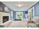 Inviting living room featuring a fireplace, French doors, and a treadmill at 5642 Falkirk Dr, Durham, NC 27712