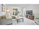 Comfortable living room with neutral tones, plush seating, and lots of natural light at 5642 Falkirk Dr, Durham, NC 27712