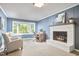 Cozy office space with blue walls, a brick fireplace, and a large bay window that offers an outside view at 5642 Falkirk Dr, Durham, NC 27712