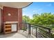 Relaxing balcony with outdoor kitchen space overlooking lush greenery and pool at 618 N Boylan Ave # 622, Raleigh, NC 27603
