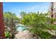 Aerial view of a pristine swimming pool surrounded by lush greenery at 618 N Boylan Ave # 622, Raleigh, NC 27603