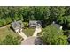 An aerial view of a home with mature trees, landscaping, and driveway at 624 Moultonboro Ave, Wake Forest, NC 27587