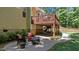 Backyard brick patio area features cozy seating near the grill, with a wooden deck overhead at 624 Moultonboro Ave, Wake Forest, NC 27587