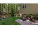 Cozy brick patio area with comfortable seating and a grill, perfect for outdoor entertaining in the backyard at 624 Moultonboro Ave, Wake Forest, NC 27587