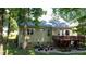 Well-maintained backyard featuring a large wooden deck, brick patio, and green lawn at 624 Moultonboro Ave, Wake Forest, NC 27587