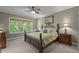 Cozy bedroom featuring a decorative iron bed frame, ceiling fan, and ample natural light at 624 Moultonboro Ave, Wake Forest, NC 27587