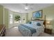 Sun-filled bedroom with a large bay window, floral bedding, and a ceiling fan at 624 Moultonboro Ave, Wake Forest, NC 27587