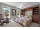 Comfortable bedroom featuring a built-in headboard and shelving, plus natural light from two windows at 624 Moultonboro Ave, Wake Forest, NC 27587
