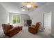 Bonus room features comfortable leather chairs, a television, plus natural light from a bright window at 624 Moultonboro Ave, Wake Forest, NC 27587