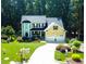 Beautiful two-story home with attached two-car garage and driveway with mature landscaping and green lawn at 624 Moultonboro Ave, Wake Forest, NC 27587