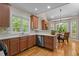Modern kitchen with stainless steel appliances, bright countertops, and wood cabinets at 624 Moultonboro Ave, Wake Forest, NC 27587