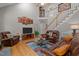 Comfortable living room with leather furniture, a tall staircase, and lots of natural light at 624 Moultonboro Ave, Wake Forest, NC 27587