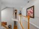 Upstairs hallway featuring staircase and decorative art at 624 Moultonboro Ave, Wake Forest, NC 27587