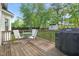 Back deck with patio furniture and a grill, overlooking a yard at 6324 Daybreak Dr, Wake Forest, NC 27587