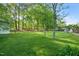 Expansive backyard with lush green lawn and mature trees at 6324 Daybreak Dr, Wake Forest, NC 27587