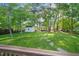 Large backyard with stone pathway and storage shed viewed from deck at 6324 Daybreak Dr, Wake Forest, NC 27587