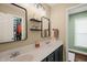 Bathroom with double sinks, sleek modern mirrors, floating shelves, and neutral colors at 6324 Daybreak Dr, Wake Forest, NC 27587