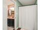 Bathroom featuring a sink with dark cabinets, a mirror and a shower with a white curtain at 6324 Daybreak Dr, Wake Forest, NC 27587